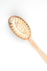 Wooden brush isolated on white. Spa beauty concept. Massage brush for the body. Vertical photo