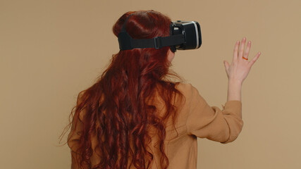 Woman using headset helmet to play simulation game app online. Watching virtual reality 3D 360...