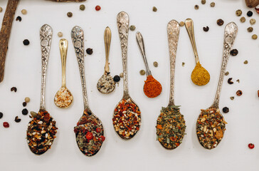 Spoons with spices and copy space. Colourful spices mix on the spoon