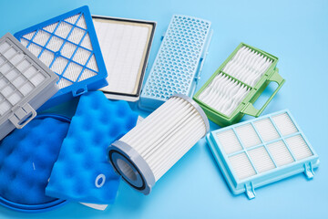 New clean dust air filters for vacuum cleaner isolated on blue background - obrazy, fototapety, plakaty