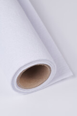 Soft felt textile material white color, colorful texture fabric roll closeup