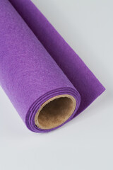 Soft felt textile material royal purple colors, colorful texture fabric roll closeup