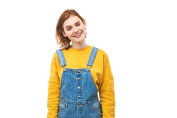 Fototapeta premium Portrait of attractive red-haired girl in yellow casual smiling joyfully isolated on white studio background
