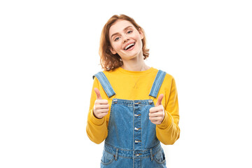 Young redhead woman shows hand with thumbs up and smiles at the camera isolated on white background