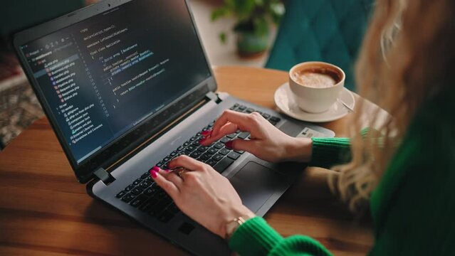 freelancer woman web-designer or software developer working in cafe, closeup of hands and display