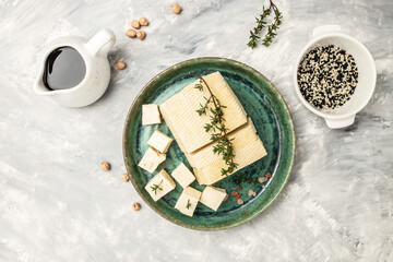Raw organic vegetarian tofu cubes on a light background. banner, menu, recipe place for text, top view