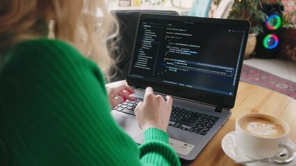 freelancer programmer and data scientist woman working with laptop in cafe, view on display