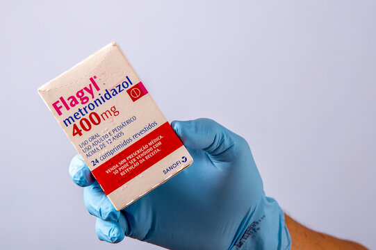 Rio, Brazil - January 27, 2023, hand with protective rubber glove holding medicine box, metronidazole
