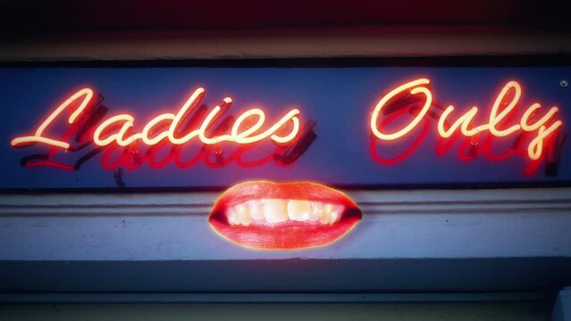 Neon Lights Ladies Only Sign Female Mouth Crazy Expressions Motion Background. Playful female mouth under a ladies only neon sign flickering lights, feminism concept. Motion background
