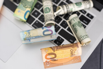 US dollars in closeup on laptop.