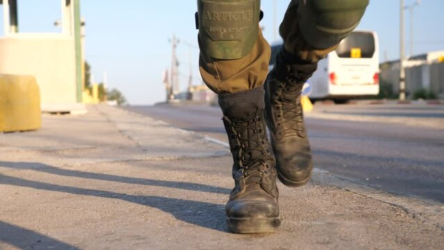 low angle shot of soldier's in combat boots approaching