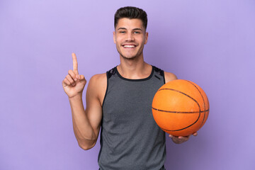 young caucasian woman  basketball player man isolated on purple background showing and lifting a finger in sign of the best