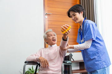 Hands of senior man or patient doing exercise with rubber squeezing a stress yellow ball for loosen...