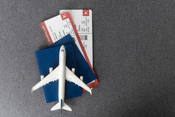 Plane tickets, passports and toy plane on table