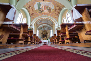 Catholic church interior with pews, statues and altar