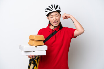 Young Chinese delivery woman taking takeaway food isolated on white background celebrating a victory