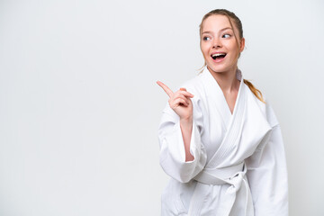 Young caucasian girl doing karate isolated on white background intending to realizes the solution while lifting a finger up