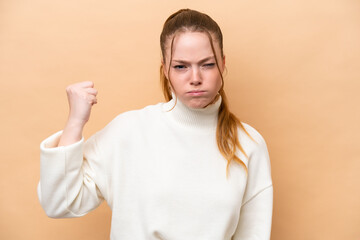 Young caucasian woman isolated on beige background with unhappy expression