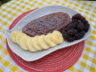 Black glutinous rice stuffed with coconut and toddy palm with banana and mulberry