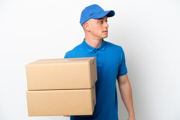 Young delivery Brazilian man isolated ops white background looking to the side