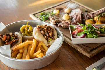 hamburger, French fries and delicious beef on the table
