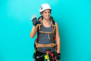 Young Italian rock-climber woman isolated on blue background counting five with fingers