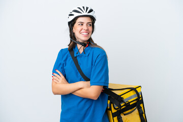Young delivery woman with thermal backpack isolated on white background with arms crossed and happy