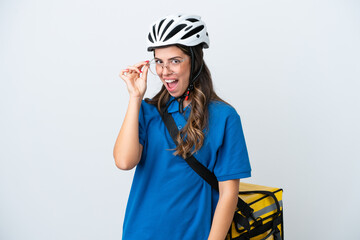 Young delivery woman with thermal backpack isolated on white background with glasses and surprised