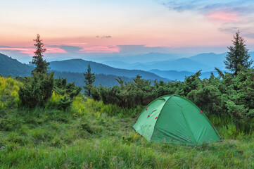 tent in the carpathian mountains at beautiful sunset