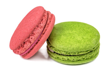 two delicious macaroon cookies on white background