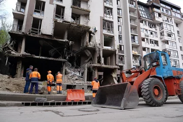 Foto op Plexiglas Workers clear rubble after bombing. Dwelling house damaged by russian missile © Harmony Video Pro