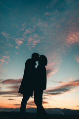 Silhouette of Couple kissing at sunset