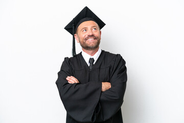 Middle age university graduate man isolated on white background looking up while smiling
