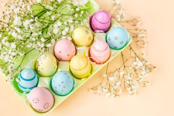 Fototapeta na wymiar Packaging with colorful eggs and flowers . Easter background for design