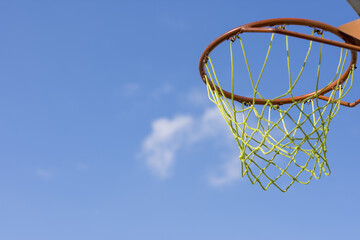 Basketball hoop on blue sky 