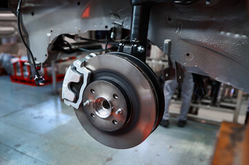Assembled car suspension with brake mechanism in workshop