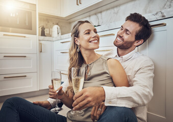 Celebrate, love and couple with champagne in kitchen for honeymoon, anniversary and valentines day. Happy, relax and young man and woman drinking alcohol on the floor with conversation in marriage