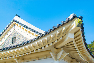 Roofer at work, installing clay roof tiles,Construction roofer installing roof tiles at house building site