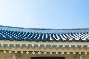 Roofer at work, installing clay roof tiles,Construction roofer installing roof tiles at house building site