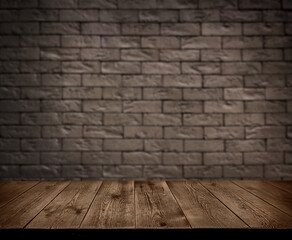 An empty wooden countertop against a black brick wall. Home interior. Copy space
