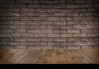 An empty wooden countertop against a black brick wall. Home interior. Copy space