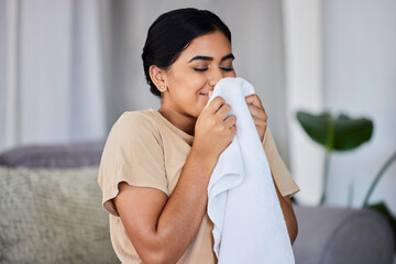 House, cleaning and woman smelling laundry on a sofa, happy and relax alone in her home. Fresh, linen and smiling domestic worker excited for freshness, results and soft fabric in household chores - obrazy, fototapety, plakaty