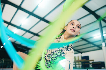 Gymnastics, ribbon dancer and woman doing a sport, fitness and dance performance in a gym. Moving,...