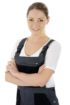 Female Mechanic Or Craftsman In Dungarees As Work Clothes, Isolated On White In Studio