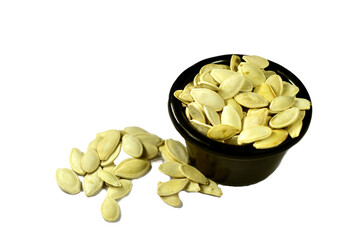 pumpkin seeds in a black bowl isolated without background