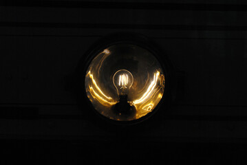 Close Up of Filament Bulb in Brass Reflector 