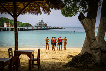 Triathletes in the Huatulco bay Mexico. Triathletes starting an open water swim in the clear waters...