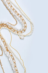 Trendy jewelry with chains and pearl necklace. Stylish golden bijouterie. Fashion accessories.