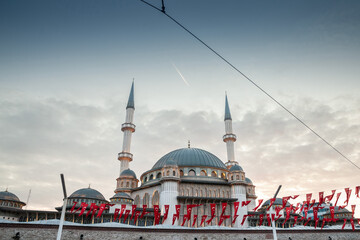 Main building of the Taksim Mosque, also called Taksim camii, with turkish flags. Taksim mosque is...