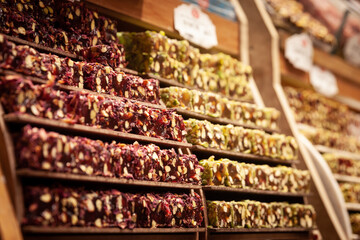 Selective blur on turkish delights, or rahalt lokum, for sale at a stall of Istanbul Misir Carsisi spice market. Lokum is an ottoman traditional confection sweet..